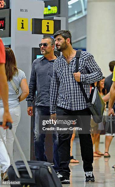 George Michael and his boyfriend Fadi Fawaz are seen at Barcelona El Prat Airport on July 29, 2012 in Barcelona, Spain.