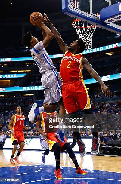 Elfrid Payton of the Orlando Magic attempts a shot over Patrick Beverley of the Houston Rockets during the game at Amway Center on January 14, 2015...