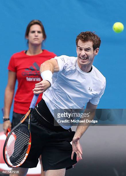 Andy Murray of Great Britain serves in front of coach Amelie Mauresmo during a practice session ahead of the 2015 Australian Open at Melbourne Park...