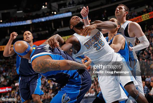 Kenneth Faried of the Denver Nuggets battles for rebounding position with Charlie Villanueva of the Dallas Mavericks at Pepsi Center on January 14,...