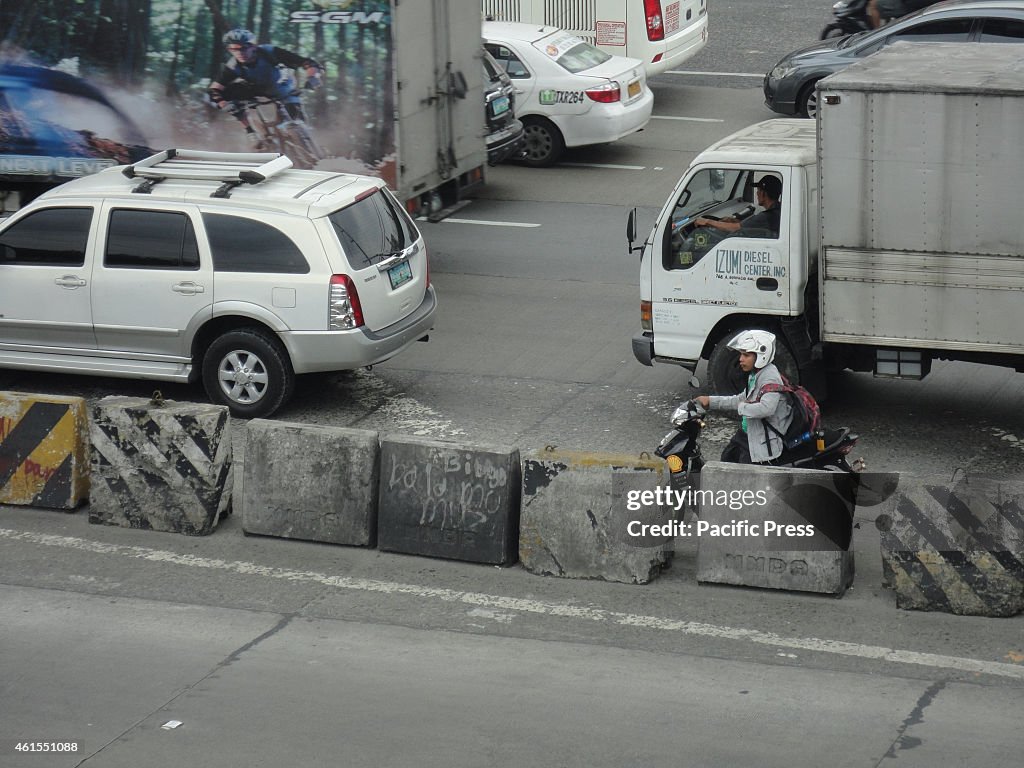 A Filipino motorcycle driver prepares to leave after...
