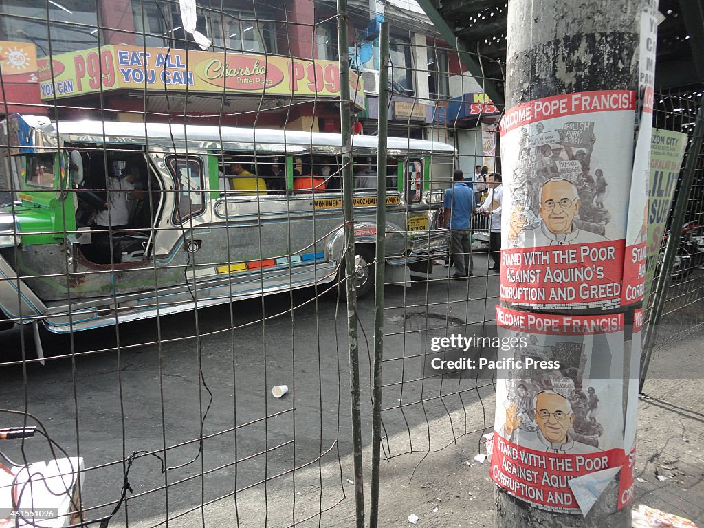 Posters from activist groups welcoming Pope Francis' visit...