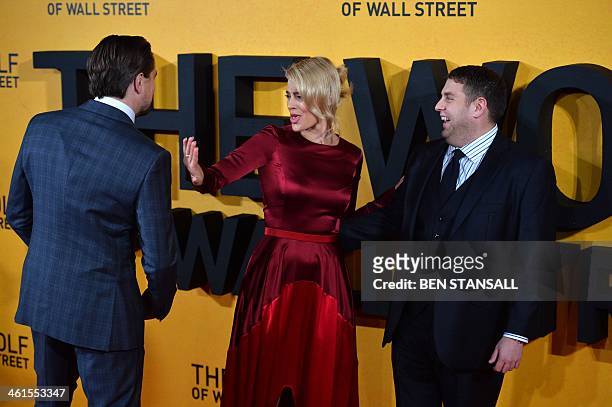 Australian actress Margot Robbie jokes with US actor Leonardo DiCaprio as US actor Jonah Hill stands by as they arrive on the red carpet to attend...