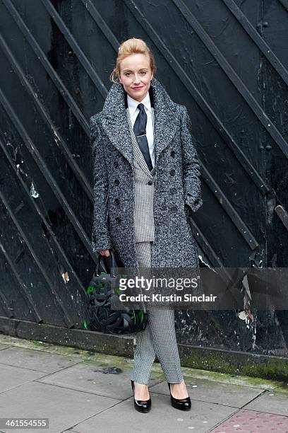 Group fashion editor for the Rake Magazine Sarah Ann Murray wears a Burberry Prossum coat, bespoke suit, Bally bag, LK Bennett shoes and Hermes tie...