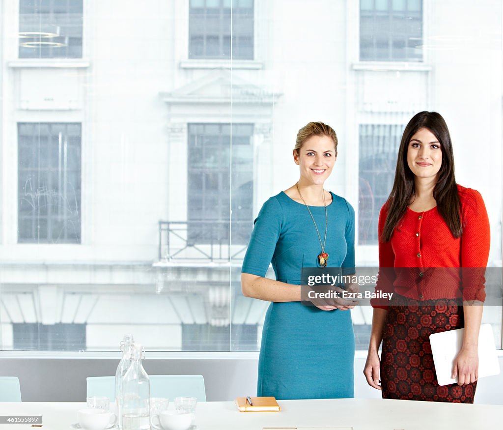 Portrait of two business women in modern office.