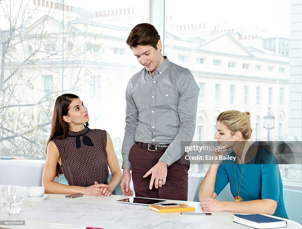 Business people in a modern office chatting.