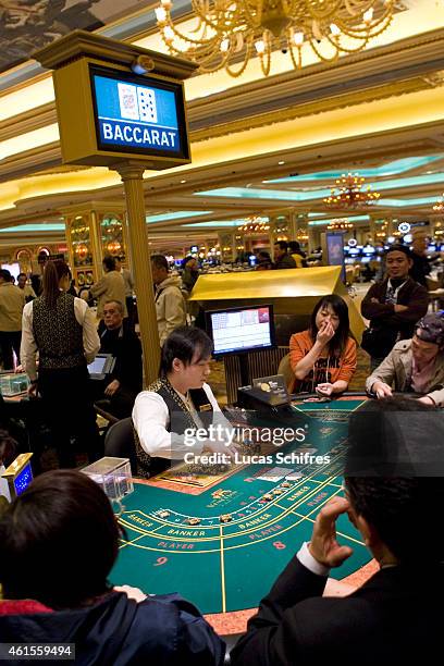 December 17: Gamblers play Baccarat in Venetian casino on December 17, 2009 in Macao, China.