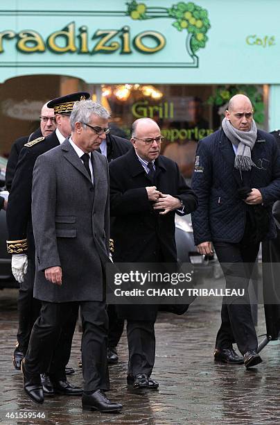 French Interior minister Bernard Cazeneuve flanked by Bernay's Mayor Herve Maurey , arrives to attend the funeral of Franck Brinsolaro, the police...