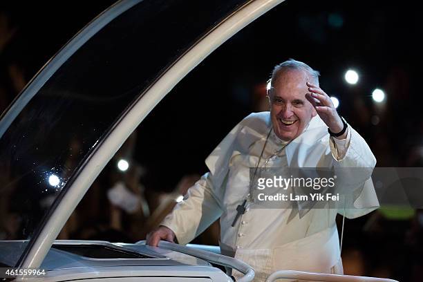 Pope Francis waves to the faithful upon his arrival in Manila city on January 15, 2015 in Manila, Philippines. Pope Francis will visit venues across...