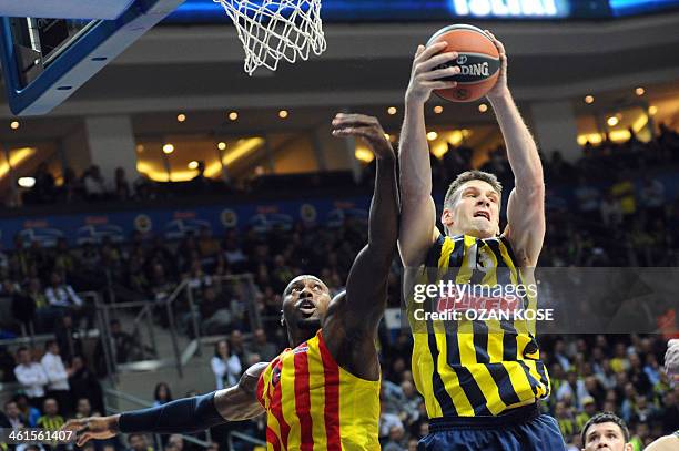 Barcelona's Joey Dorsey challenges Fenerbahce's Gasper Vidmar during the Euroleague Top 16 group E basketball match between Fenerbahce and Barcelona...