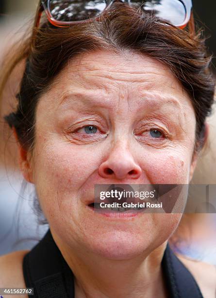 Woman cries during a tribute to the 17 victims of this week's Islamists militant attacks in France at Embassy of France on January 11, 2015 in Buenos...