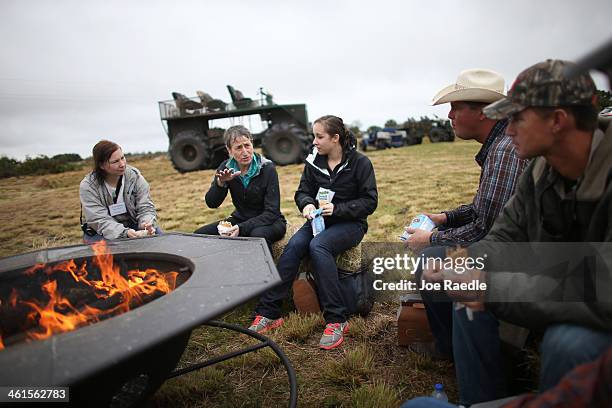 Secretary of the Interior Sally Jewell sits with Christine McGowan , Emily Paciolla, Jay Belflower and Jake Carlton during a visit to meet with...