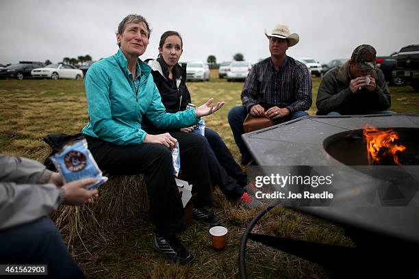 Secretary of the Interior Sally Jewell sits with Emily Paciolla, Jay Belflower and Jake Carlton during a visit to meet with ranchers and private...