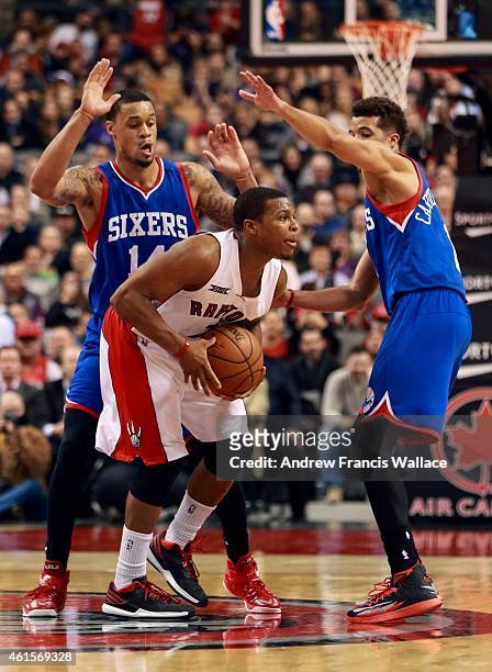 Toronto Raptors Kyle Lowry calls a timeout while being pressured by Philadelphia 76ers K.J. McDaniels and Michael Carter-Williams during fourth...