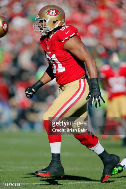 Defensive tackle Ray McDonald of the San Francisco 49ers gets up to celebrate after sacking quarterback Russell Wilson of the Seattle Seahawks for a...