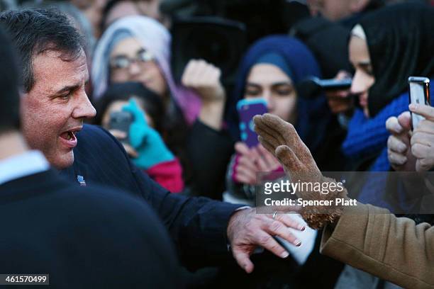 New Jersey Gov. Chris Christie shakes hands with residents after leaving the Borough Hall in Fort Lee where he apologized to Mayor Mayor Mark...