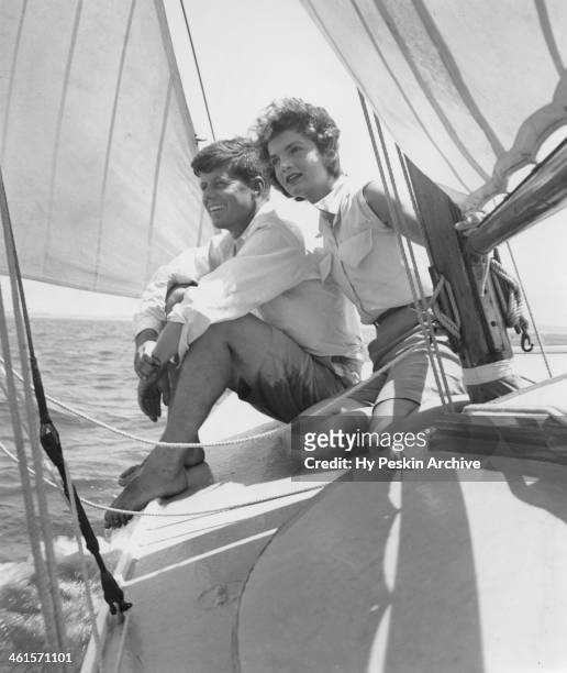 Senator John F. Kennedy and fiance Jacqueline Bouvier go sailing while on vacation at the Kennedy compound in June 1953 in Hyannis Port,...