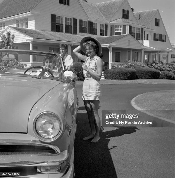 Senator John F. Kennedy and fiance Jacqueline Bouvier chat with Patricia Kennedy while on vacation at the Kennedy compound in June 1953 in Hyannis...