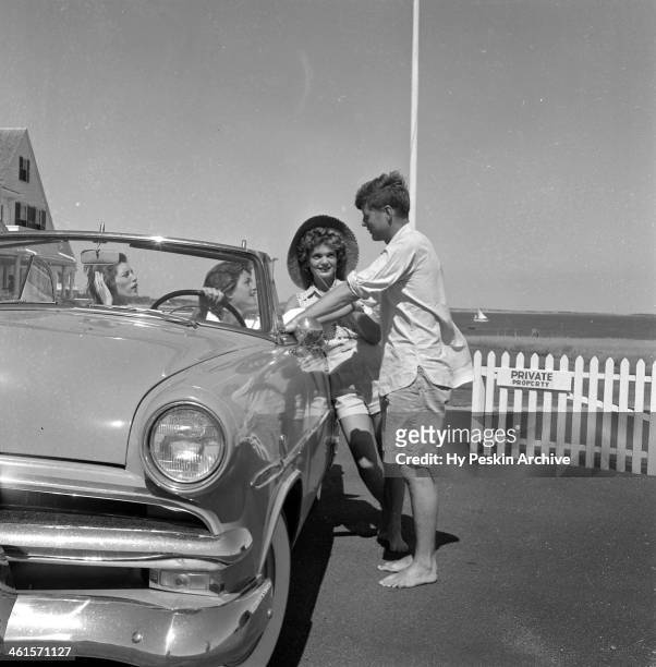 Senator John F. Kennedy and fiance Jacqueline Bouvier chat with Eunice Kennedy and Patricia Kennedy while on vacation at the Kennedy compound in June...