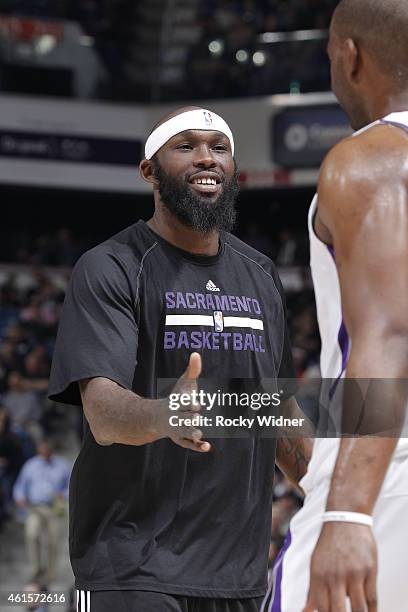 Reggie Evans of the Sacramento Kings high fives a teammate against the Denver Nuggets on January 9, 2015 at Sleep Train Arena in Sacramento,...