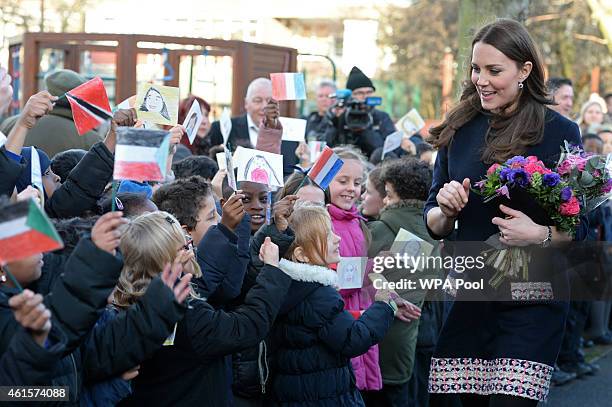 Catherine, Duchess of Cambridge is given a bouquet of flowers as she visits Barlby Primary School on January 15, 2015 in London, England. The Duchess...