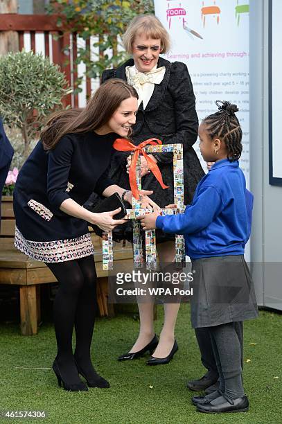 Catherine, Duchess of Cambridge greets school children as Grayson Perry looks on as they visit Barlby Primary School on January 15, 2015 in London,...