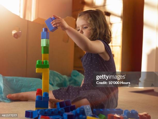 3 year old girl stacking blocks in bedroom - 3 years brunette female alone caucasian stock pictures, royalty-free photos & images