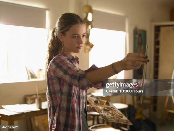 young woman painting - banbossy stock pictures, royalty-free photos & images