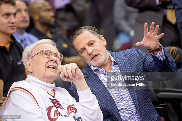 Warren Buffet talks with Cleveland Cavaliers owner Dan Gilbert the Charlotte Hornets during the second half at Quicken Loans Arena on December 15,...