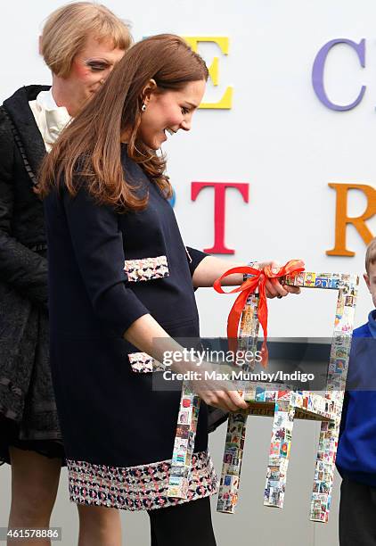 Catherine, Duchess of Cambridge, Royal Patron of The Art Room, is presented with a childs chair during a visit to the Clore Art Room at Barlby...