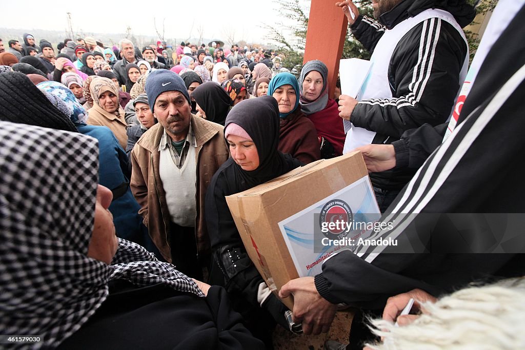 Syrian refugees in Lebanon receive food aid from the Turkish Cooperation and Coordination Agency