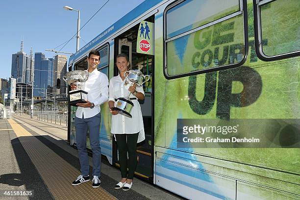 Novak Djokovic of Serbia and Victoria Azarenka of Belarus arrive on a tram prior to the 2014 Australian Open official draw at Melbourne Park on...
