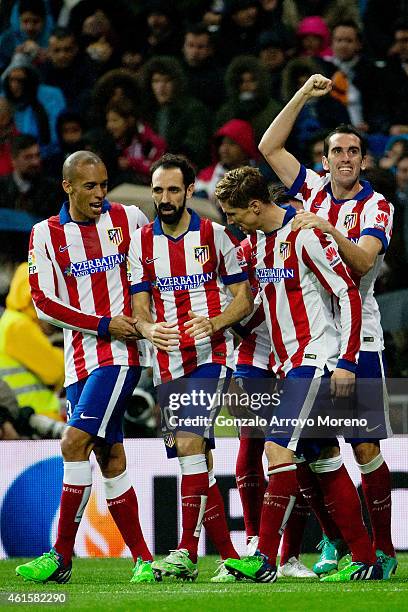 Fernando Torres of Atletico de Madrid celebrates scoring their second goal with teammates Diego Godin , Juan Francisco Torres alias Juanfran and Joao...