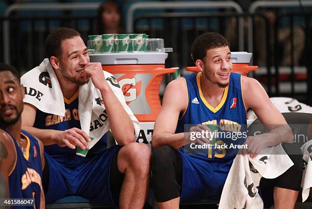 Mychel Thompson and Seth Curry of the Santa Cruz Warriors known as the Junior Splash Brothers look on from the bench during the game against the Rio...
