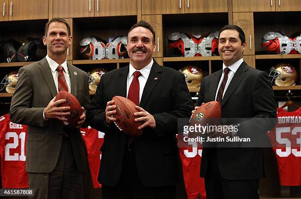 Jim Tomsula stands with San Francisco 49ers CEO Jed York and 49ers general manager Trent Baalke following a press conference at Levi's Stadium on...