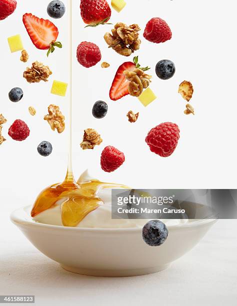bowl of yogurt with honey, fruit, and granola - yogurt bildbanksfoton och bilder