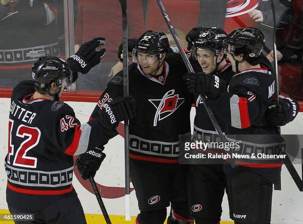 Carolina Hurricanes' John-Michael Liles celebrates his goal against the Toronto Maple Leafs with teammates Zach Boychuk and Ryan Murphy during the...
