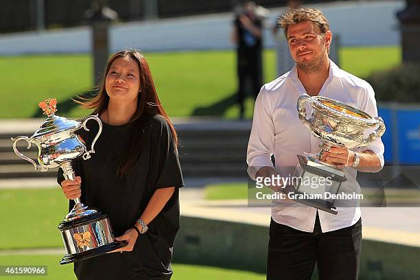 Na Li of China and Stan Wawrinka of Switzerland walk with the Daphne Akhurst Memorial Cup and the Norman Brookes Challenge Cup as they arrive for the...