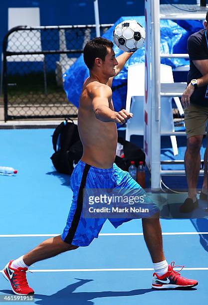 Bernard Tomic of Australia warms up before a training session on back courts during day five of the 2014 Sydney International at Sydney Olympic Park...