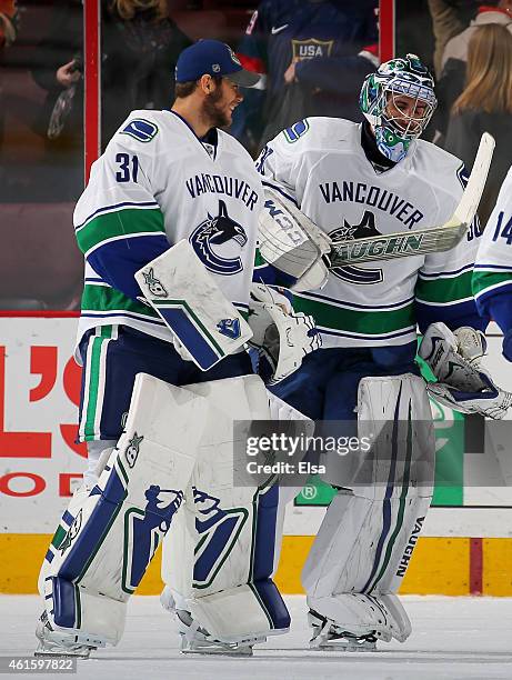 Ryan Miller of the Vancouver Canucks is congratulated by teammate Eddie Lack after Miller recorded the shut out against the Philadelphia Flyers on...