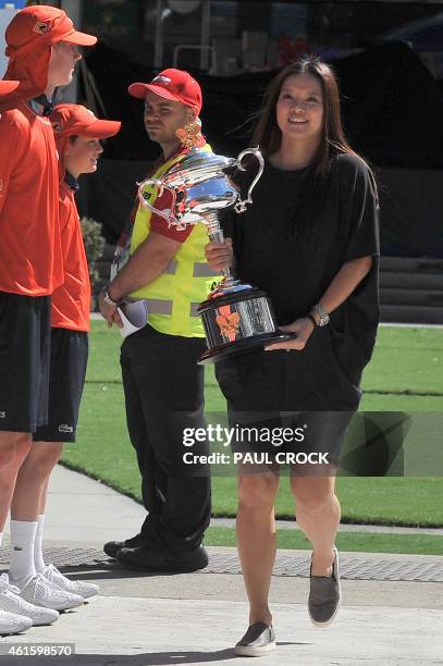 Australian Open 2014 women's singles champion, Li Na of China, arrives with the trophy ahead of the official draw for the Australian Open tennis...