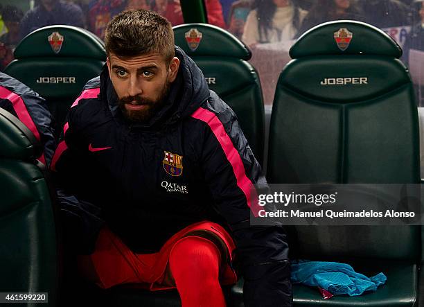 Gerard Pique of Barcelona watches from the subsitute bench prior to the Copa del Rey Round of 16 Second Leg match between Elche FC and FC Barcelona...