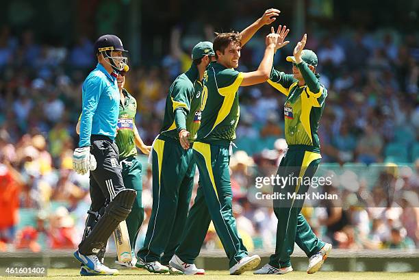 Pat Cummins of Australia celebrates with team mates after taking the wicket of Joe Root of England during the One Day International series match...