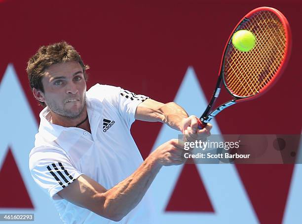 Gilles Simon of France plays a backhand during his match against Richard Gasquet of France during day three of the AAMI Classic at Kooyong on January...