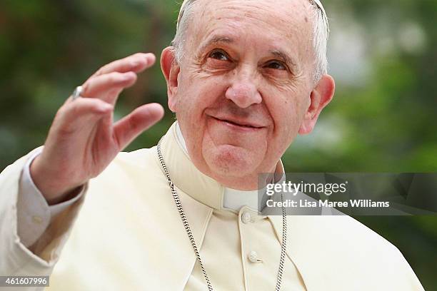 Pope Francis waves to thousands of followers as he arrives at the Manila Cathedral on January 16, 2015 in Manila, Philippines. Pope Francis will...