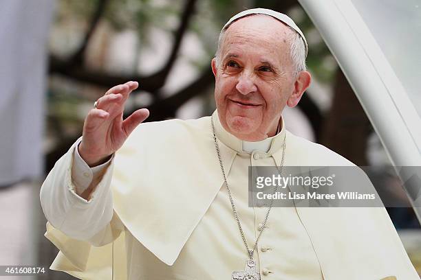 Pope Francis waves to thousands of followers as he arrives at the Manila Cathedral on January 16, 2015 in Manila, Philippines. Pope Francis will...