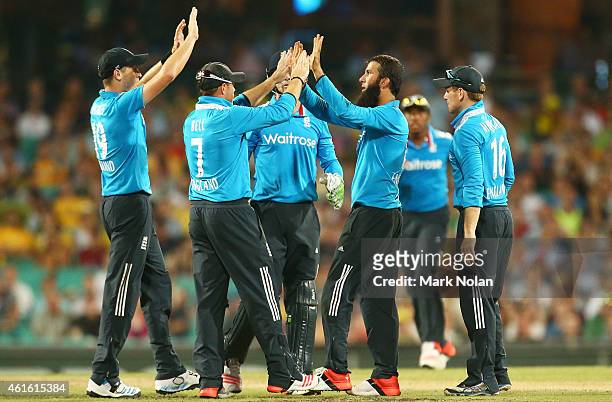 Moeen Ali of England celebrates with team mates after taking the wicket of Steve Smith during the One Day International series match between...