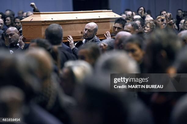 People hold the coffin of French cartoonist and Charlie Hebdo editor Stephane "Charb" Charbonnier during his funeral ceremony, on January 16, 2015 in...