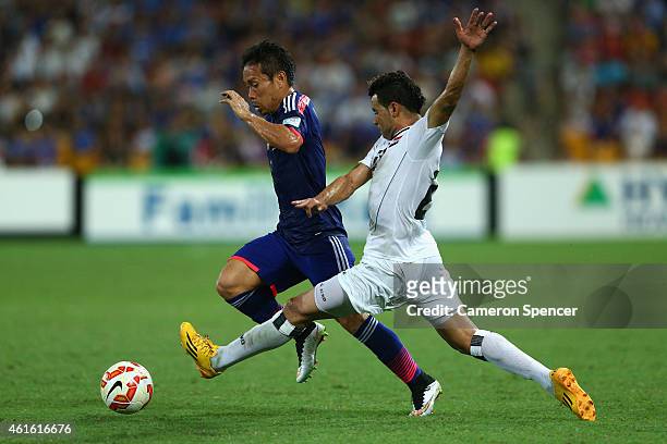 Yuto Nagatomo of Japan and Waleed Salem Al-Lami of Iraq contest the ball during the 2015 Asian Cup match between Iraq and Japan at Suncorp Stadium on...