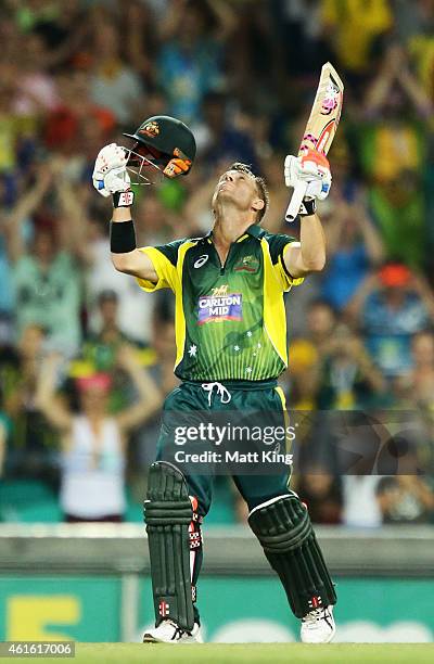 David Warner of Australia celebrates and looks skyward after scoring a century during the One Day International series match between Australia and...